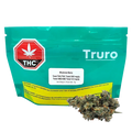 Front-facing image of a teal pouch labeled Truro Bluenose Berry with a THC symbol at left and cannabis buds placed in front.