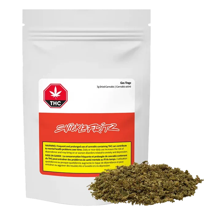 Front-facing shot of a white pouch labeled Gas Tingz with a red band and a pile of green-brown dried herb at its base.