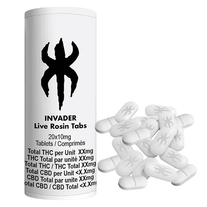 Front-facing white Invader Live Rosin Tabs bottle with black logo beside a scattered pile of oval white tablets.