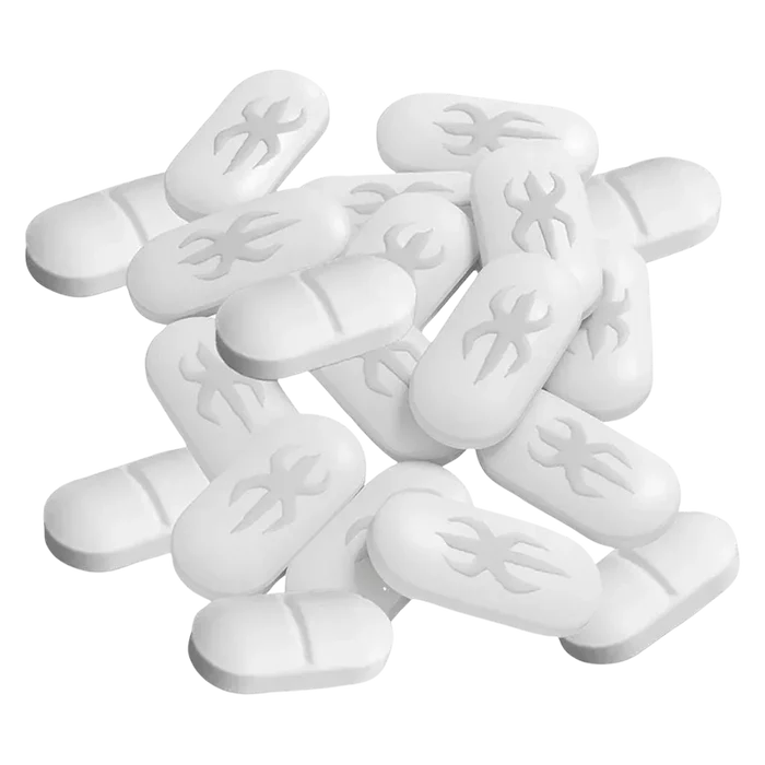 Close-up top-down view of a scattered pile of white Live Rosin Tabs showing pill-shaped tablets with a stylized flame emboss.