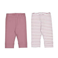 Two pairs of children's jogger-style pants laid flat on a white background: one solid dusty pink and one white with thin pink horizontal stripes.