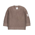 A toddler's chunky knit sweater in a warm taupe-brown color, featuring a crew neck, button closures on the shoulders, ribbed cuffs, and a small floral patch on the left sleeve.